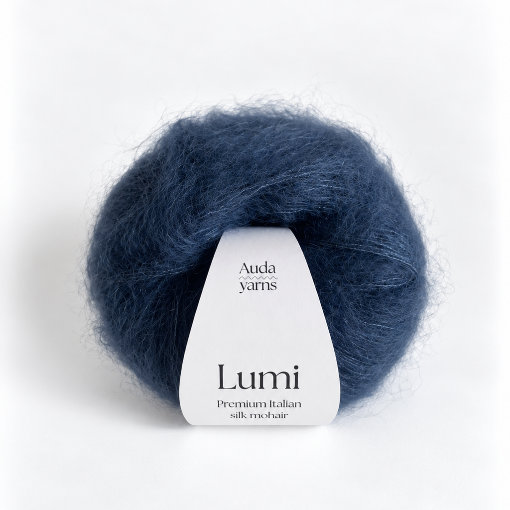 A ball of Auda Yarns Lumi premium Italian silk roving in a deep navy blue color, with a white paper label wrapped around the center, set against a clean white background.