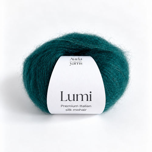 A ball of Auda Yarns Lumi premium Italian silk mohair yarn in a deep teal green color, featuring a white paper label, set against a clean white background.