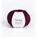 A ball of Nova Premium Italian Cashmere Wool yarn in a deep burgundy color, featuring a white paper label with black text, set against a clean white background.