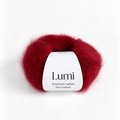 A ball of Lumi Premium Italian Silk Mohair yarn in a deep crimson red color, featuring a white paper label in the center, set against a clean white background.
