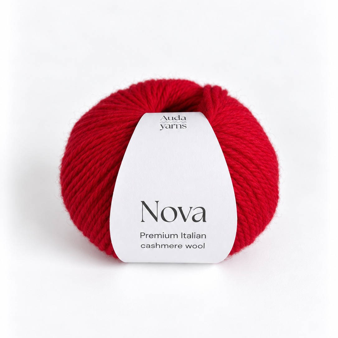 A single ball of vibrant red yarn with a white paper label reading 'Nova' and 'Auda Yarns' on a clean white background.